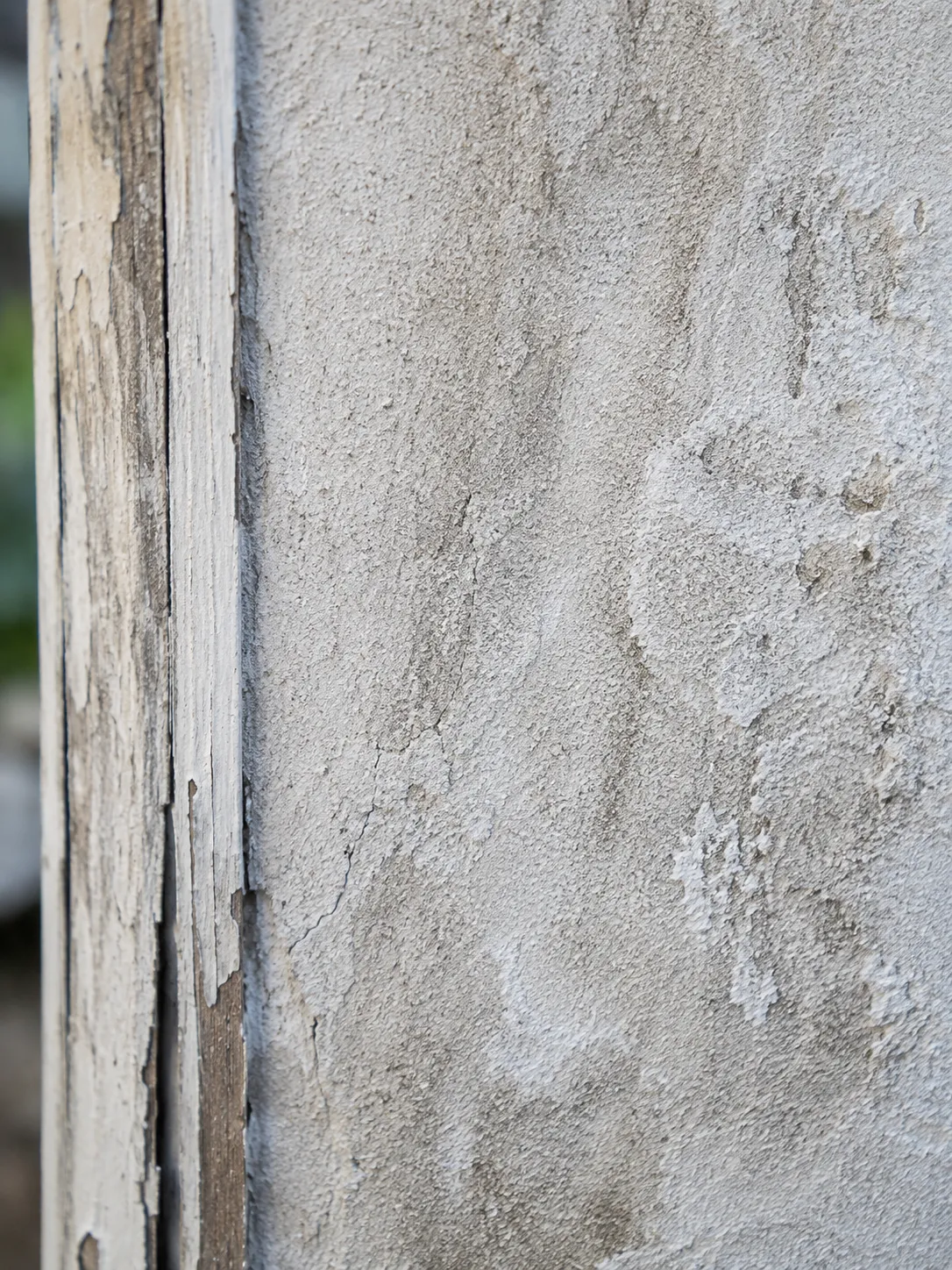 Stucco exterior wall showing signs of moisture intrusion